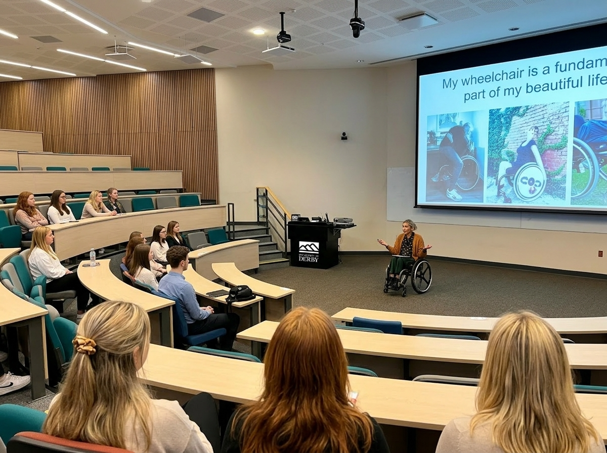 Karrie J., a mobility-disabled architect, addressing the studio cohort