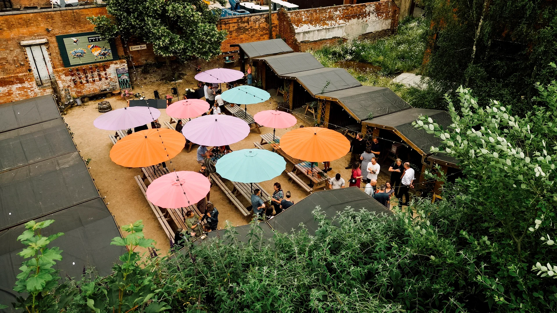 Beer and food garden in use with timber trading huts and parasols